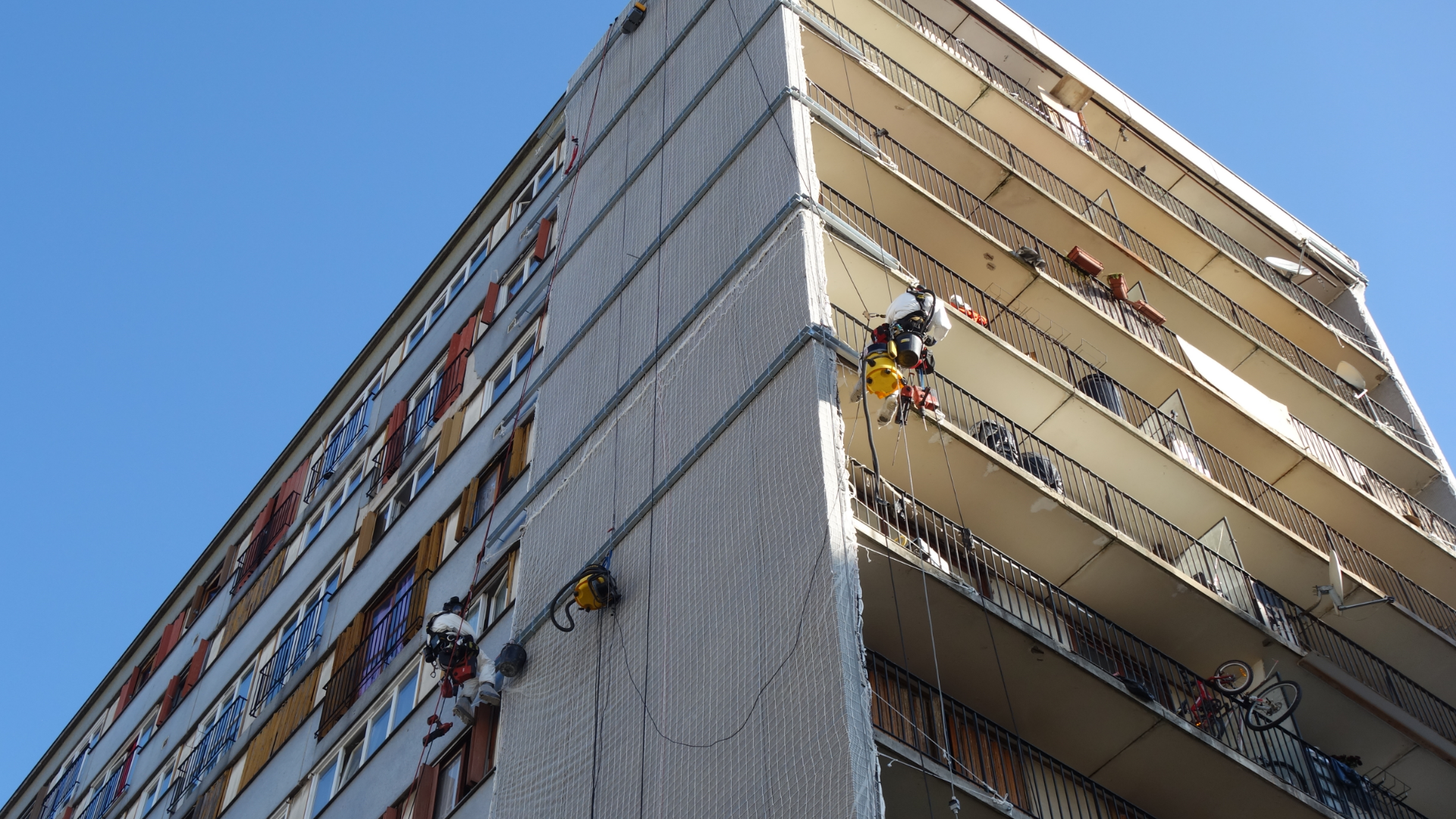 cordistes nettoyant les façades d'un immeuble